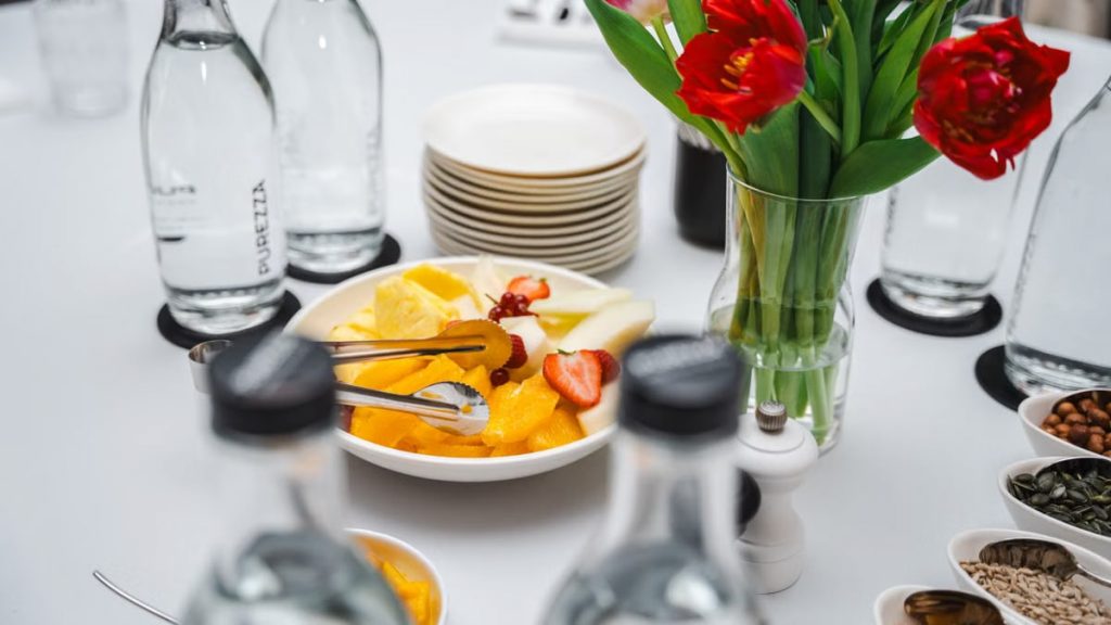 An elegant dining setup featuring fresh fruits and vibrant tulips, perfect for a healthy meal.