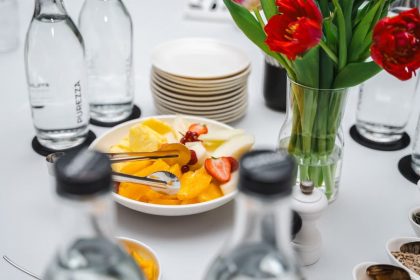 An elegant dining setup featuring fresh fruits and vibrant tulips, perfect for a healthy meal.