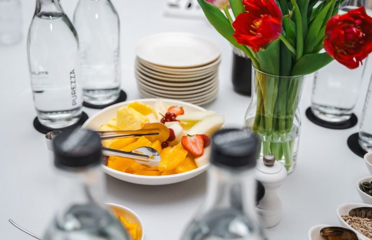 An elegant dining setup featuring fresh fruits and vibrant tulips, perfect for a healthy meal.