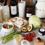 A variety of fresh ingredients and kitchen tools for preparing a healthy meal.